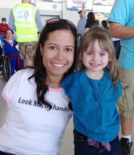 Jessica and young girl without arms smiling together
